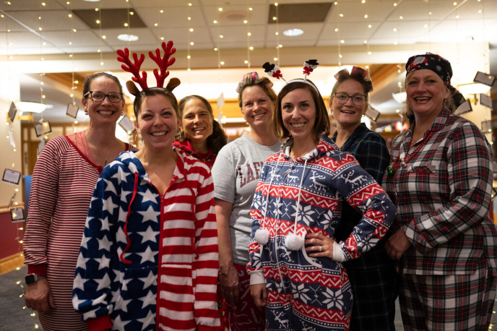 A group of people dressed in pajamas smiling at the camera.