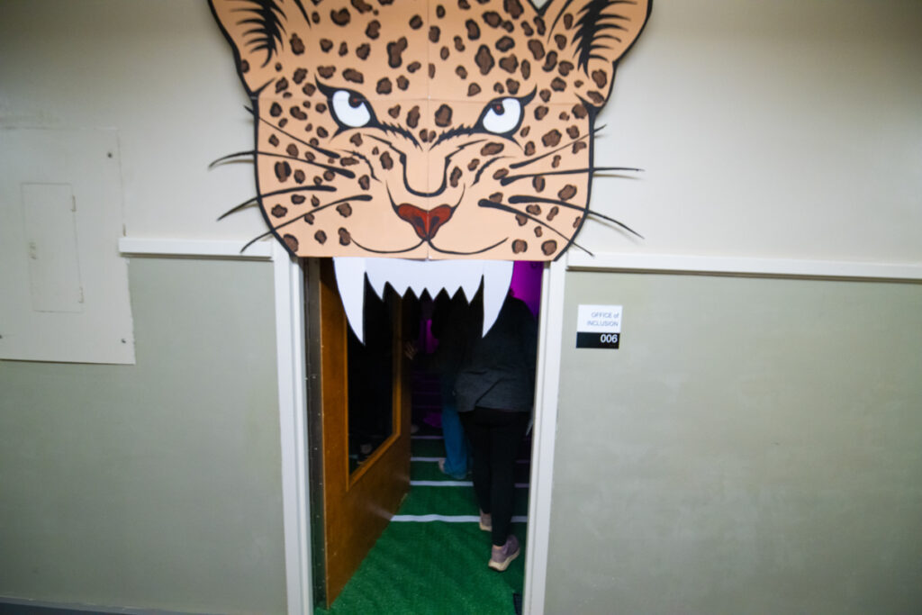 A paper Leopard head frames a doorway.