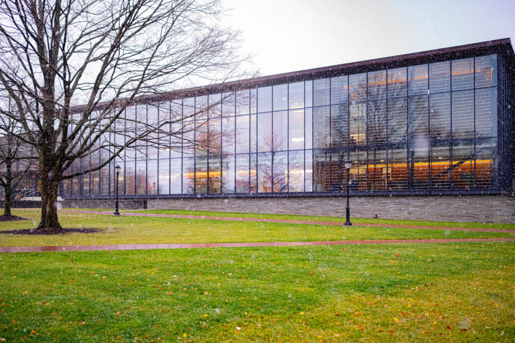 A wide show of Skillman Library as snow falls.