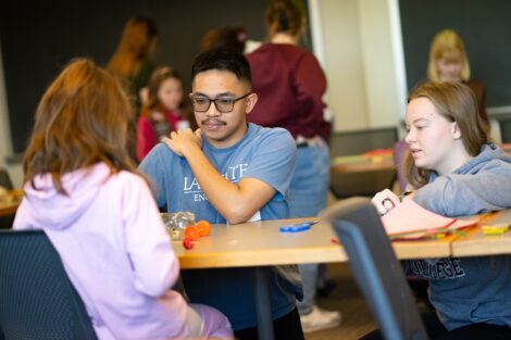 Lafayette engineering students help a young Girl Scout design her own car.