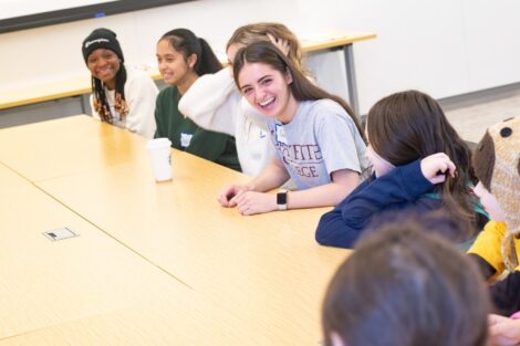 Lafayette WinC student volunteers laugh as they participate in a GS Badgge Day Session.