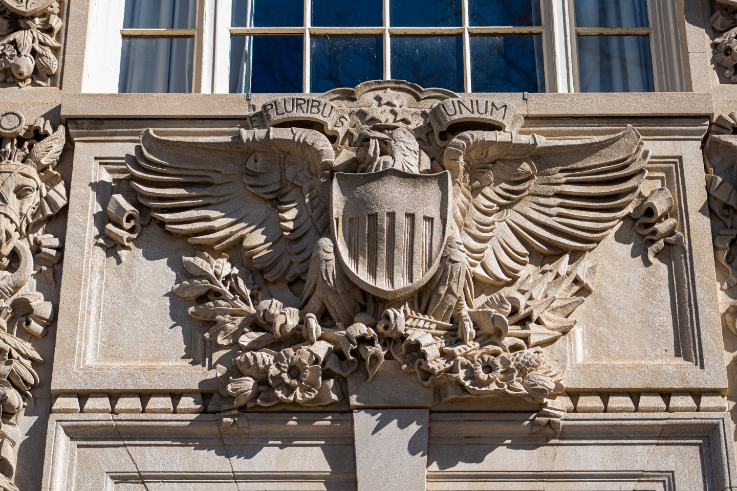 A close up of a bird sculpture on a building. Representing strength and freedom.