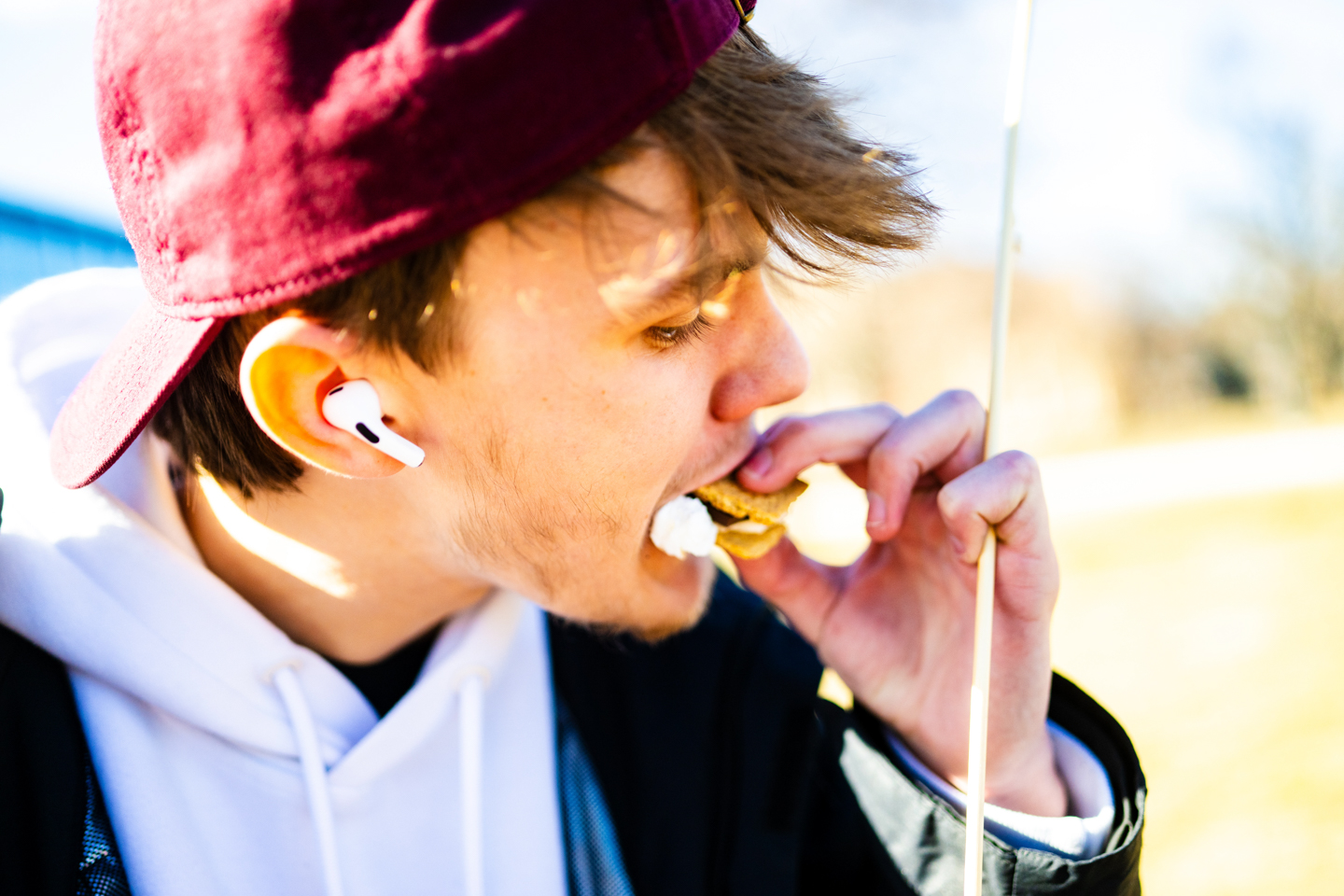 Student eating s'mores on during a Winter Festival.