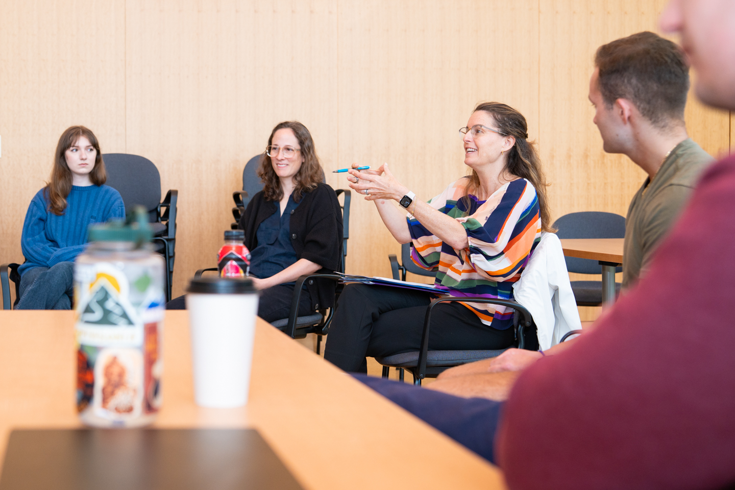 Professor Rebekah Pite and her class are discussing student presentations on global stimulants like coffee, tea, and yerba mate.