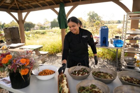Dayimin Duarte is all smiles as she readies food at farm to table breakfast.