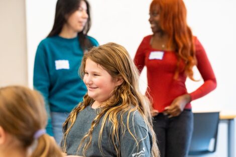 A scout beams as two Lafayette volunteers are pictured in the background.