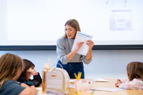 Lauren Biernacki holds up a paper in front of scouts during her coding session.