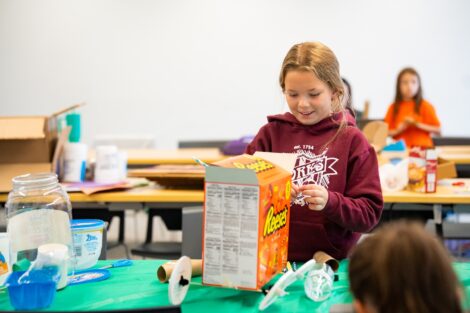 A Girl Scout builds a Mars rover with recylced materials.
