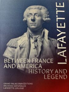 The cover of the book that accompanies the exhibit at the National Archives in France. The cover features a statue bust of Lafayette with the words Lafayette Between France and America History and Legend.