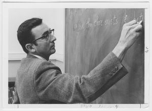 William R Jones teaching at a chalkboard.